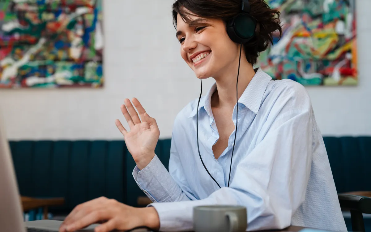 A new Shape user smiling and waving during a live training webinar