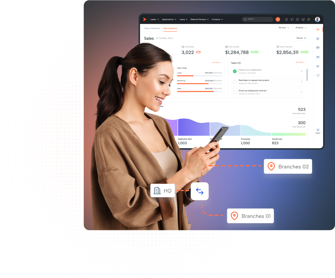 A woman checks sales data on a screen using Shape CRM for real estate lending.